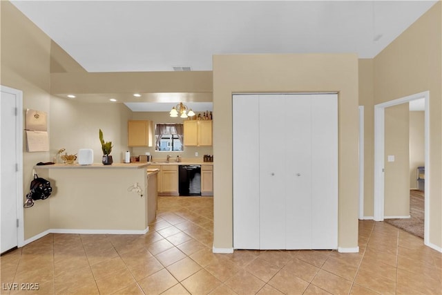 kitchen with light countertops, light tile patterned flooring, a sink, and visible vents