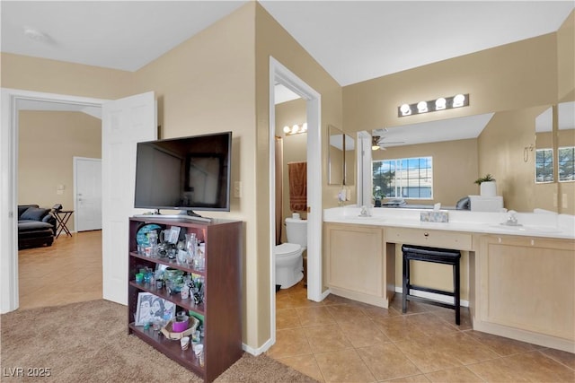 full bathroom featuring double vanity, a sink, toilet, and tile patterned floors