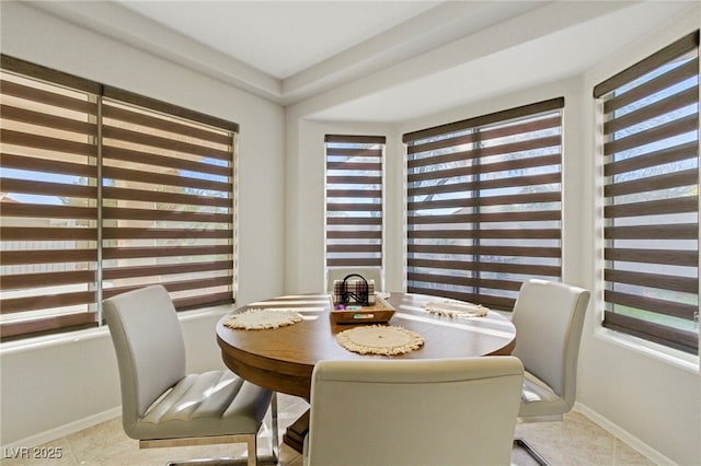 tiled dining room with baseboards