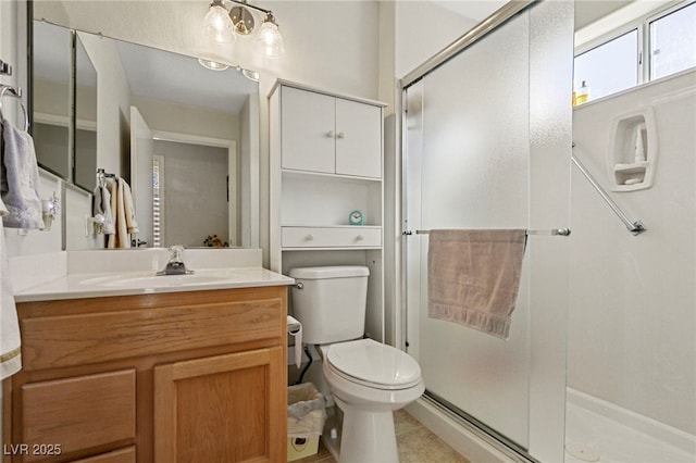 full bathroom featuring toilet, a stall shower, tile patterned floors, and vanity