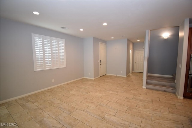 spare room featuring recessed lighting, visible vents, and baseboards