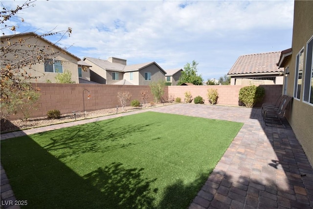 view of yard with a fenced backyard and a patio
