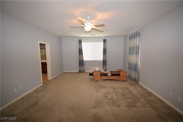 miscellaneous room with ceiling fan, carpet, and baseboards