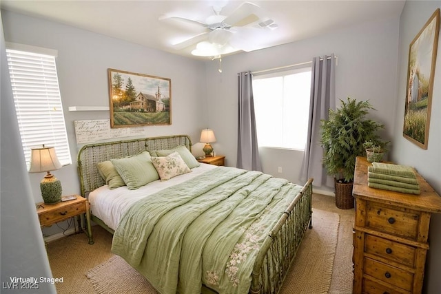 bedroom with light carpet and a ceiling fan