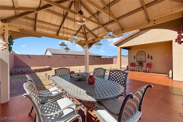 view of patio featuring outdoor dining space, a gazebo, and a fenced backyard