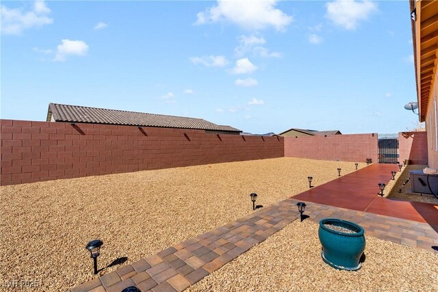 view of yard featuring a fenced backyard and a patio area