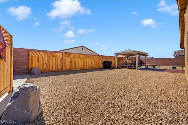 view of yard featuring a patio area, a gazebo, and a fenced backyard