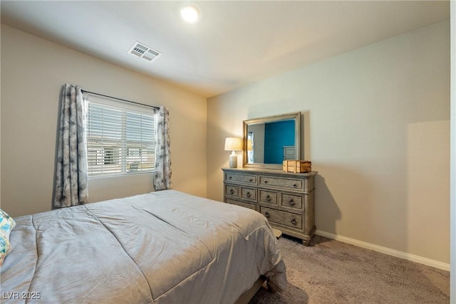 carpeted bedroom with visible vents and baseboards