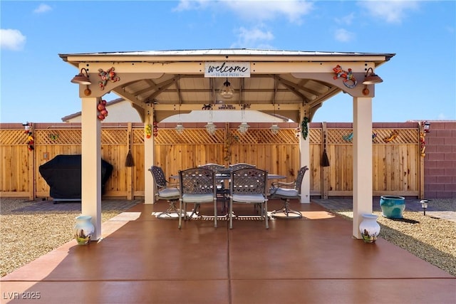 view of patio / terrace with a gazebo, outdoor dining space, and fence