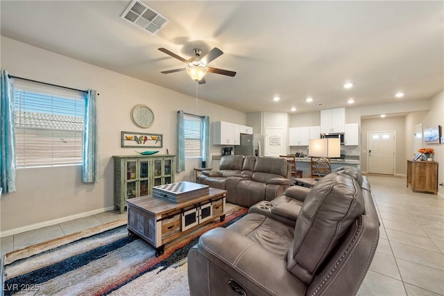 living area with visible vents, a ceiling fan, recessed lighting, light tile patterned floors, and baseboards