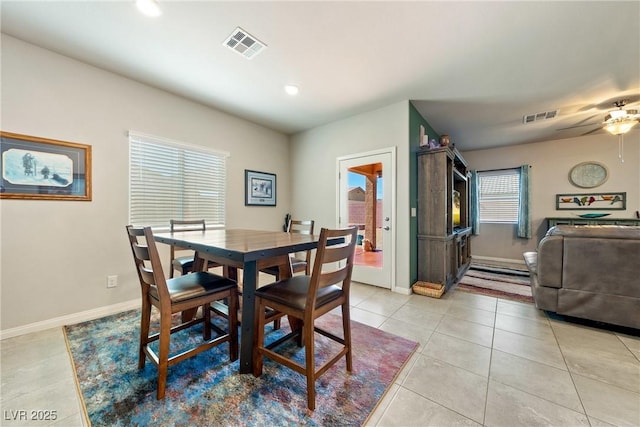 dining area featuring light tile patterned floors, baseboards, and visible vents