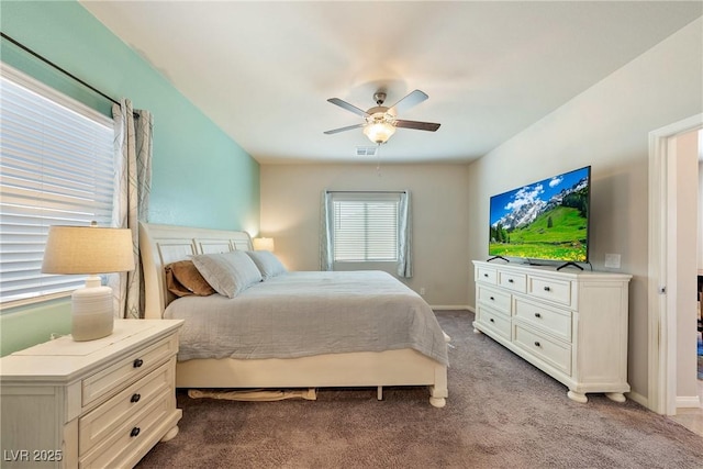 carpeted bedroom featuring visible vents, baseboards, and a ceiling fan