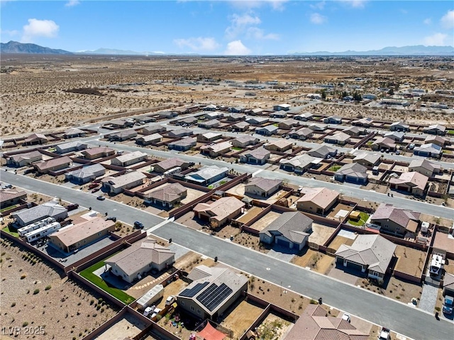 birds eye view of property featuring a mountain view, a residential view, and a desert view