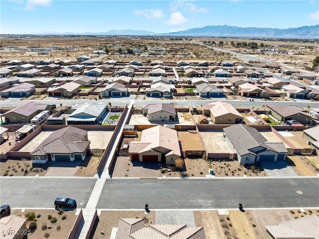 drone / aerial view featuring a residential view and a mountain view