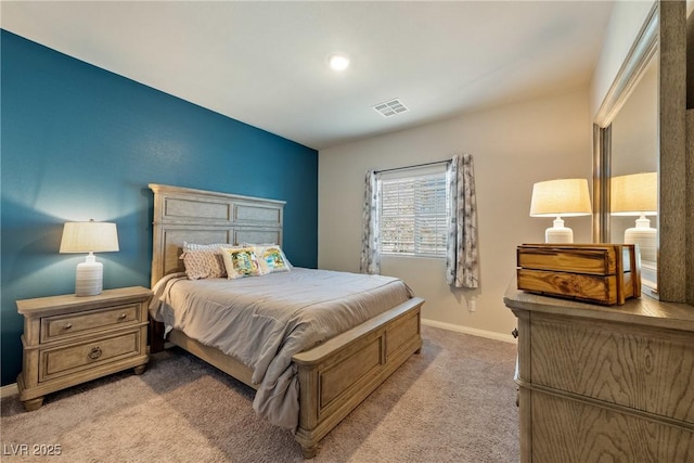 carpeted bedroom with visible vents and baseboards