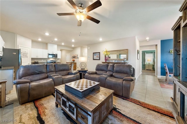 living area featuring light tile patterned flooring, recessed lighting, baseboards, and ceiling fan