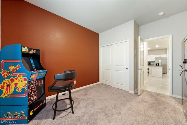 playroom featuring light colored carpet and baseboards