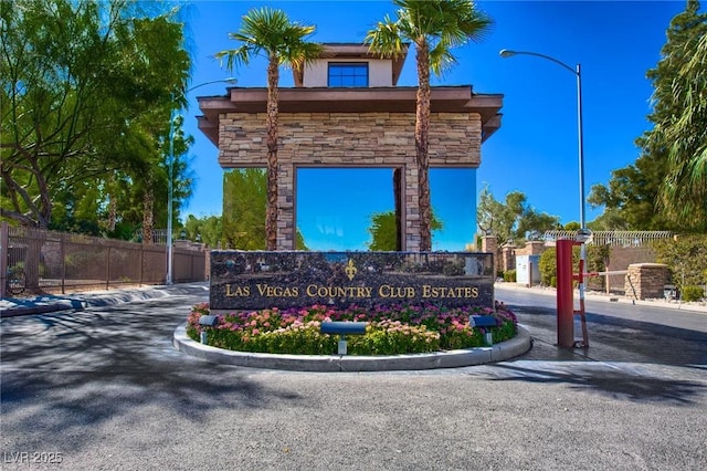 community / neighborhood sign featuring fence