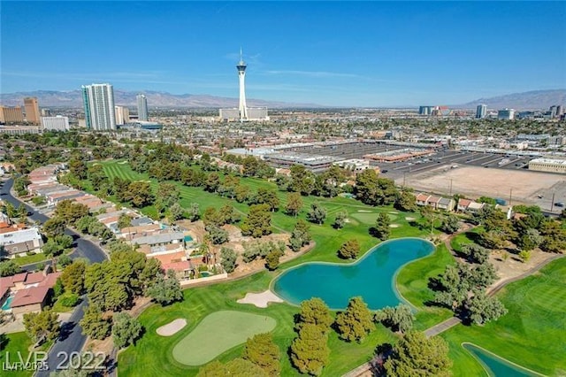 bird's eye view with a water view, golf course view, and a city view