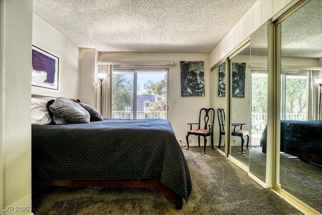 bedroom with a textured ceiling and dark carpet