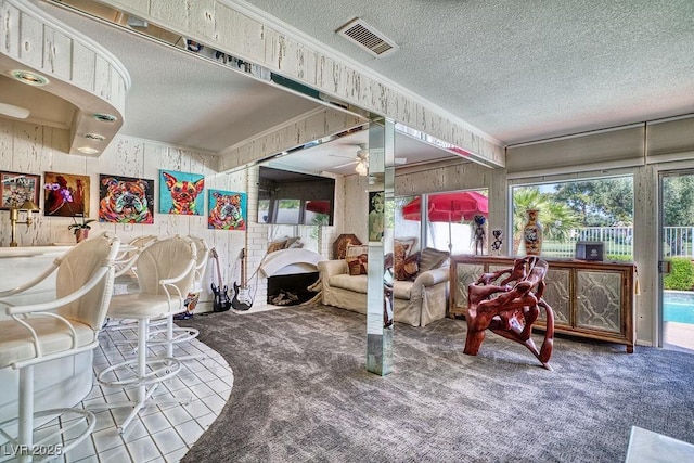 interior space featuring carpet floors, visible vents, crown molding, and a textured ceiling