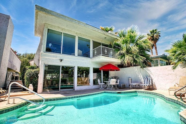 view of swimming pool with a patio area, fence, and a fenced in pool