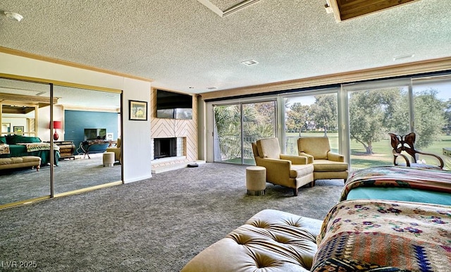 living room featuring carpet floors, a healthy amount of sunlight, a fireplace, and a textured ceiling