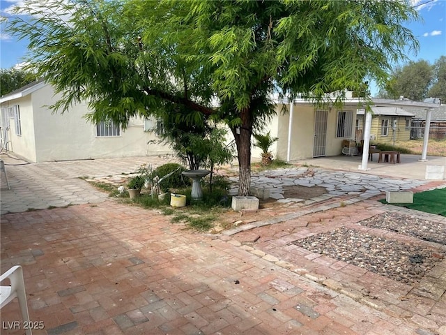 exterior space featuring a patio area and fence