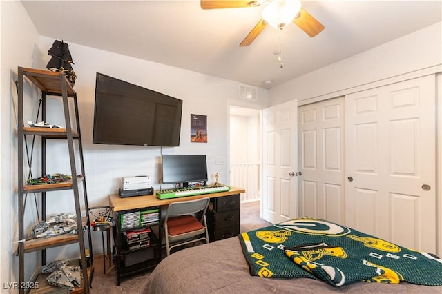 carpeted bedroom with a ceiling fan, a closet, and visible vents