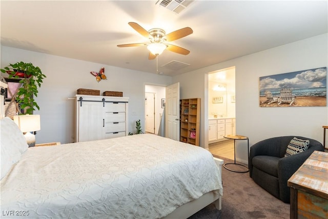 bedroom featuring ensuite bathroom, carpet floors, visible vents, and a ceiling fan