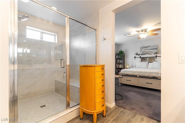 ensuite bathroom with ensuite bathroom, a stall shower, wood finished floors, and a ceiling fan