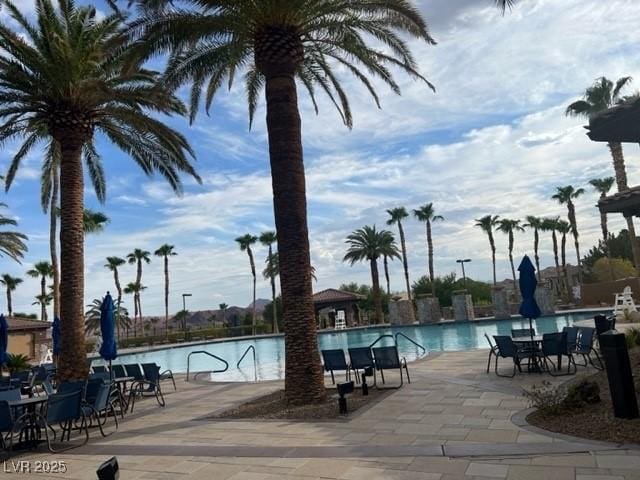 pool featuring a water slide and a patio area