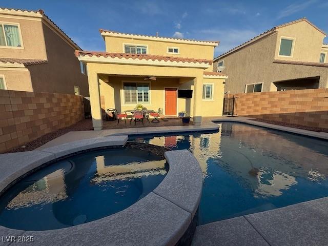 back of house featuring a fenced backyard, ceiling fan, a patio, and stucco siding