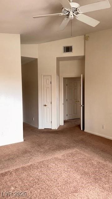 spare room with ceiling fan, carpet, and visible vents