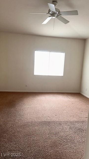 spare room with ceiling fan, carpet floors, and baseboards