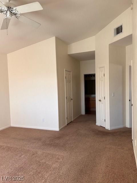 unfurnished room featuring ceiling fan, carpet, visible vents, and baseboards