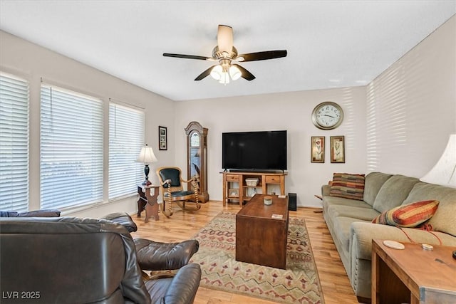 living area with light wood-style floors and ceiling fan