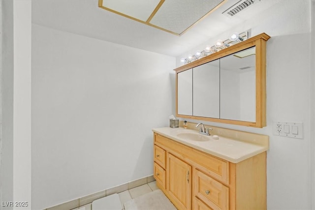 bathroom featuring vanity, tile patterned floors, baseboards, and visible vents