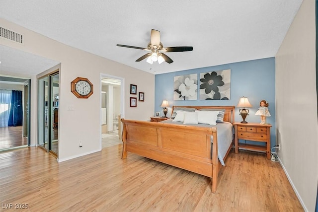 bedroom featuring visible vents, ceiling fan, light wood-type flooring, and baseboards