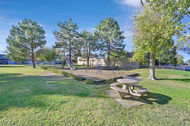 exterior space with a yard, fence, and playground community