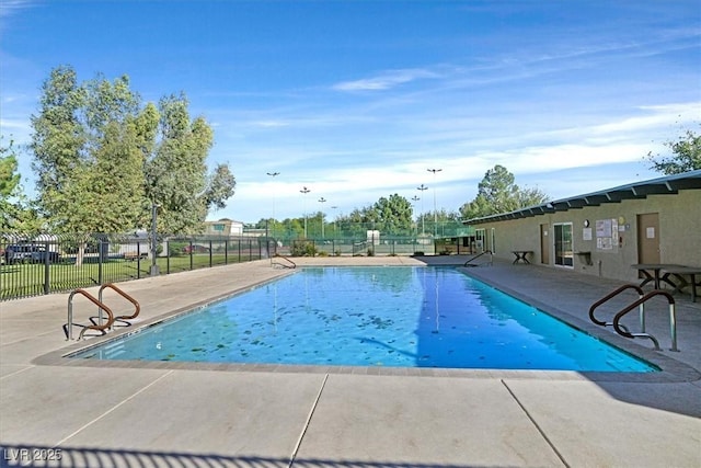 community pool featuring a patio and fence