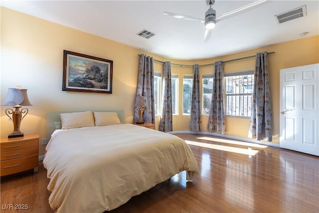 bedroom featuring visible vents, ceiling fan, and wood finished floors