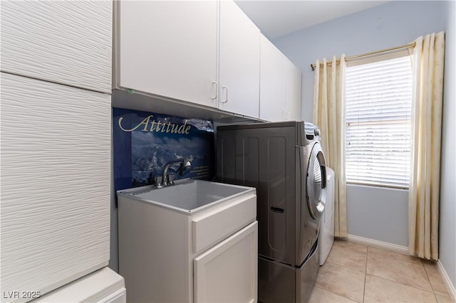 laundry room with cabinet space, baseboards, independent washer and dryer, a sink, and light tile patterned flooring