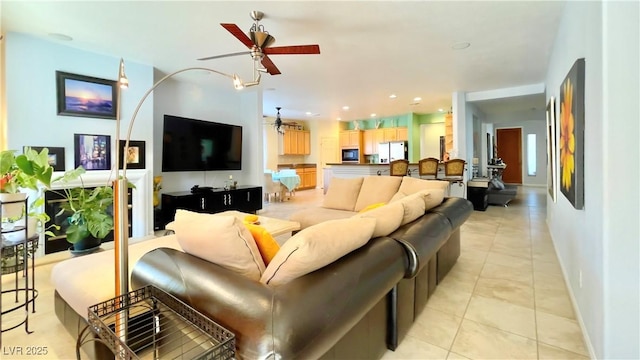 living area with recessed lighting, light tile patterned flooring, ceiling fan, and baseboards