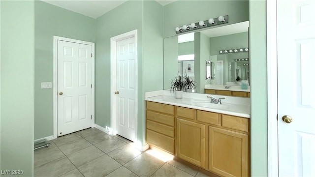 bathroom featuring tile patterned flooring, baseboards, and vanity