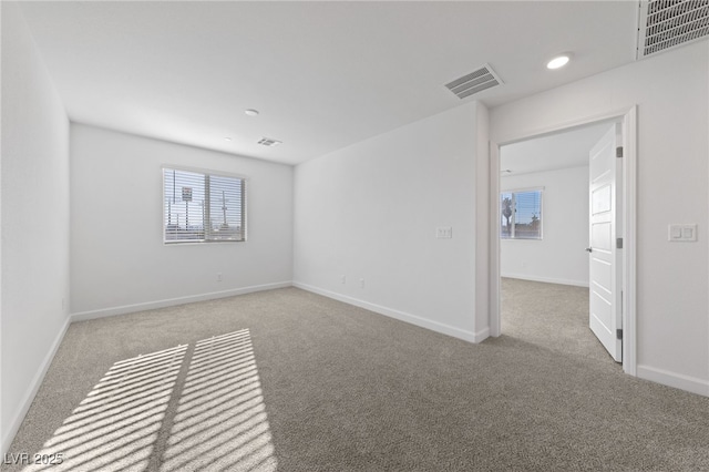 carpeted spare room with recessed lighting, visible vents, and baseboards