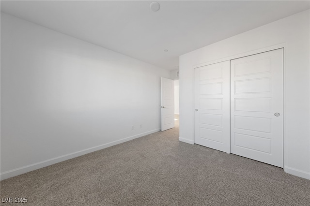 unfurnished bedroom featuring a closet, carpet flooring, and baseboards