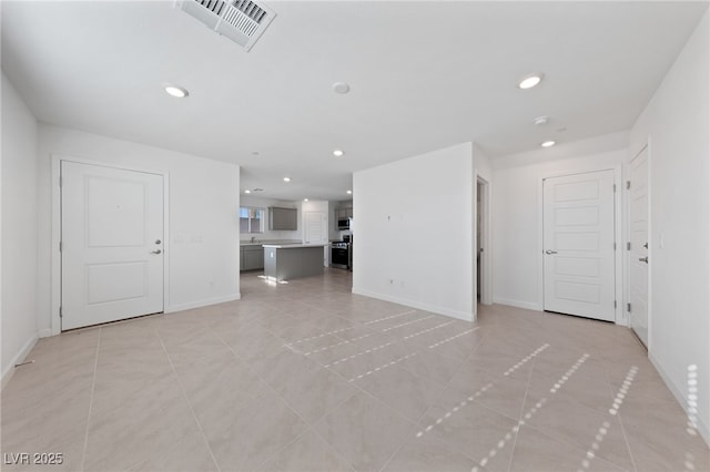 unfurnished living room featuring light tile patterned floors, baseboards, visible vents, and recessed lighting