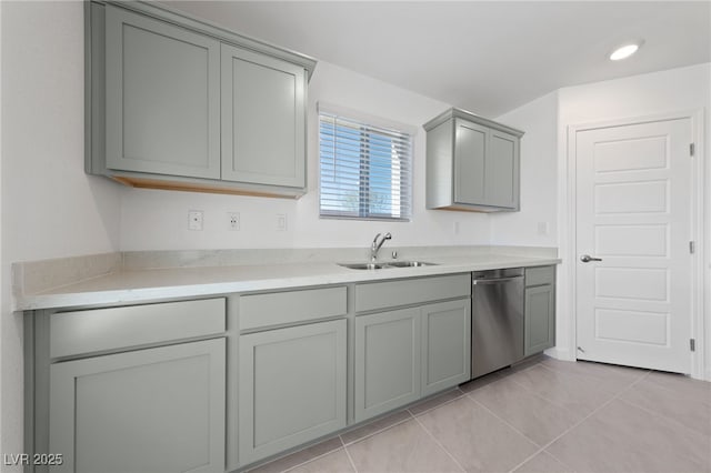 kitchen featuring a sink, light tile patterned floors, stainless steel dishwasher, and gray cabinetry