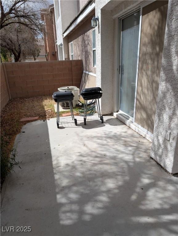 view of patio / terrace featuring fence